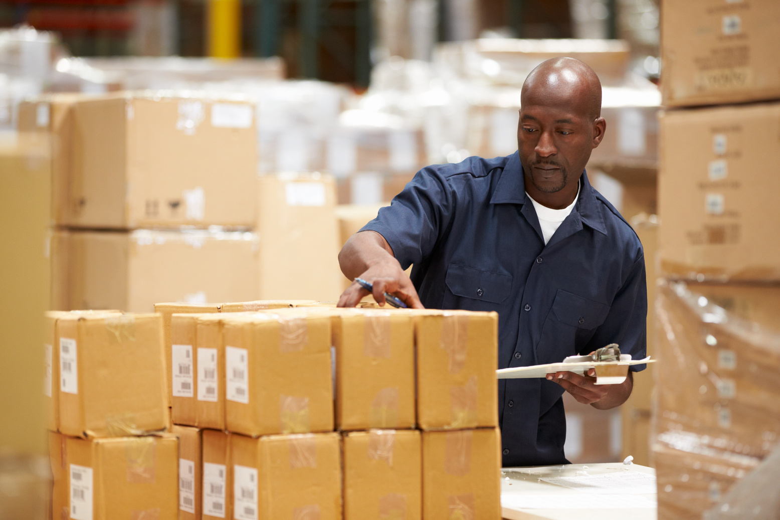 Worker in Warehouse Preparing Goods for Dispatch